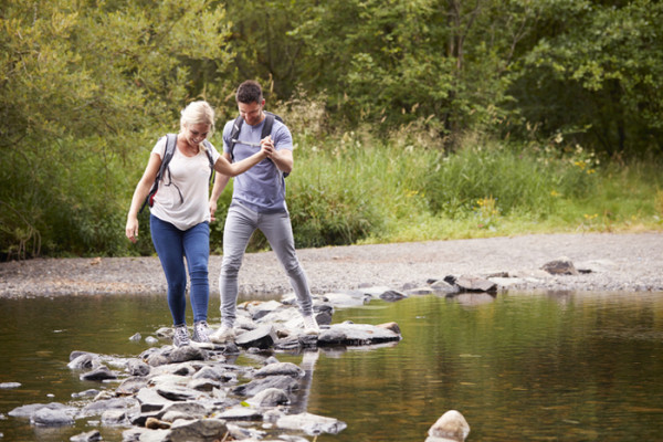Couple walking across river