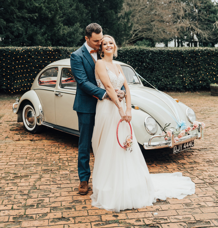 Bride and groom infront of wedding car