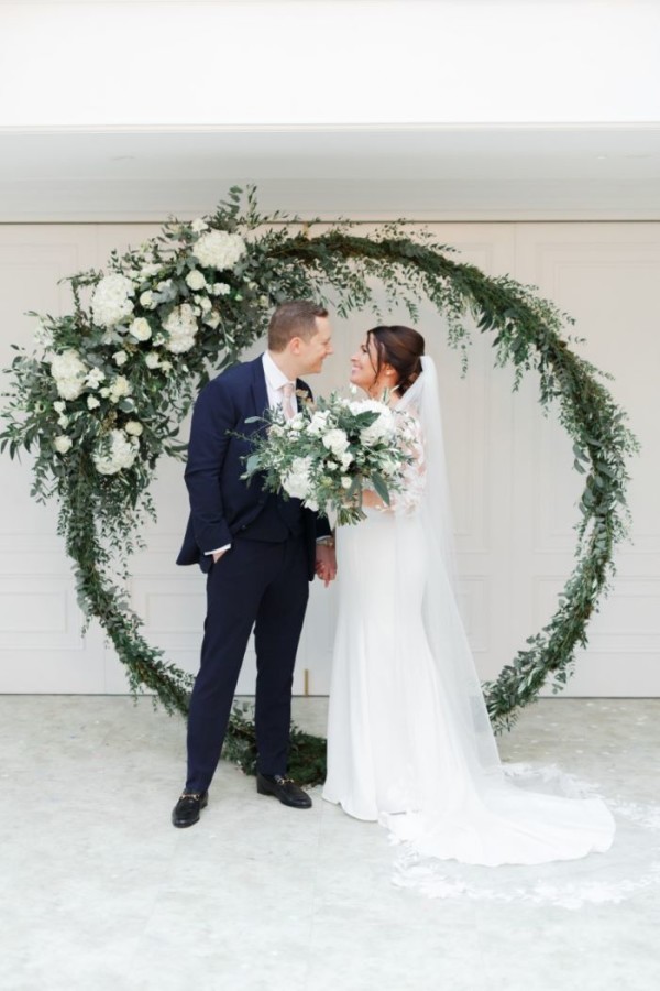 Emily & Me and White Stag greenery wedding backdrop